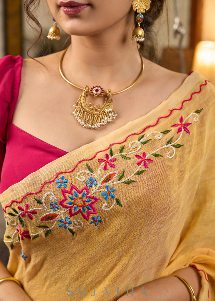 Beautiful yellow cotton saree highlighted with multicolor floral embroidery