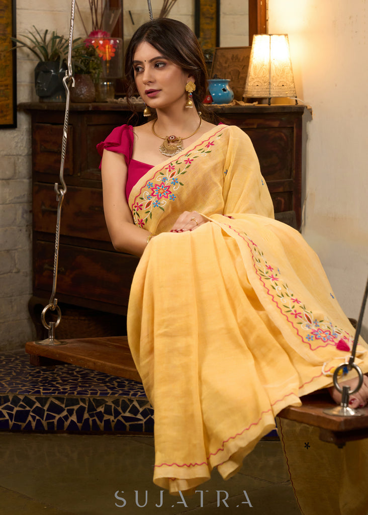 Beautiful yellow cotton saree highlighted with multicolor floral embroidery