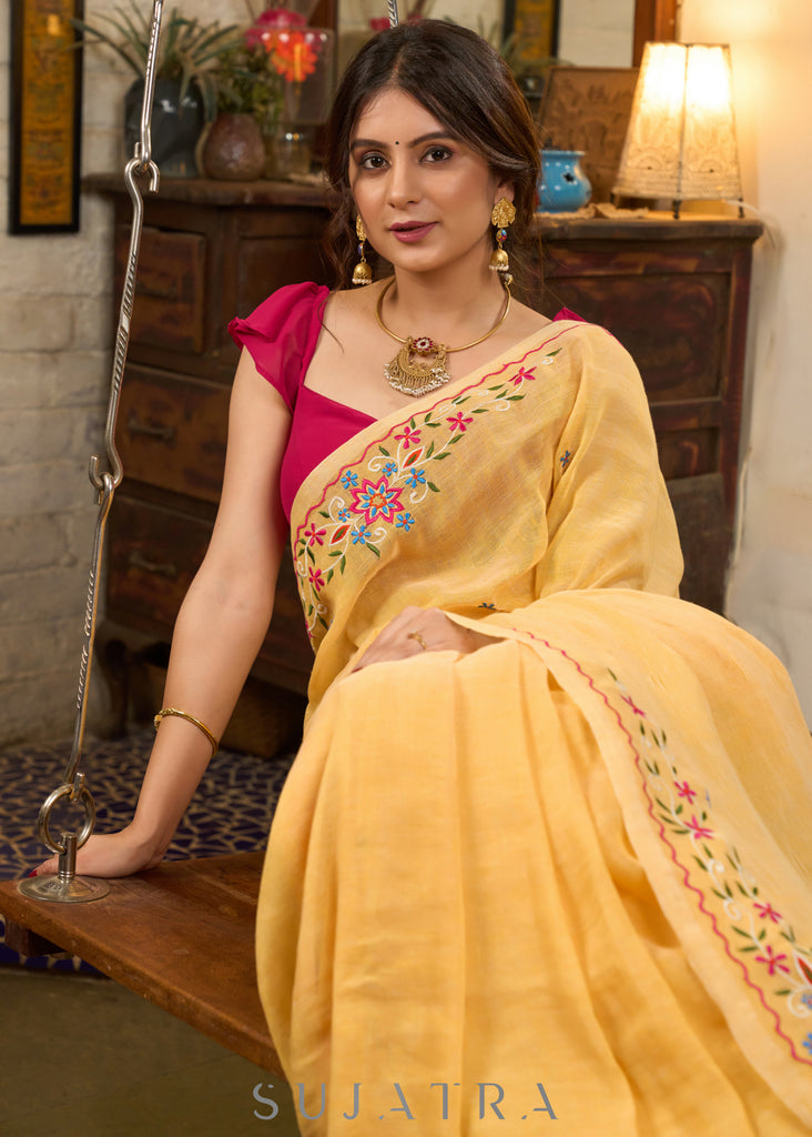 Beautiful yellow cotton saree highlighted with multicolor floral embroidery