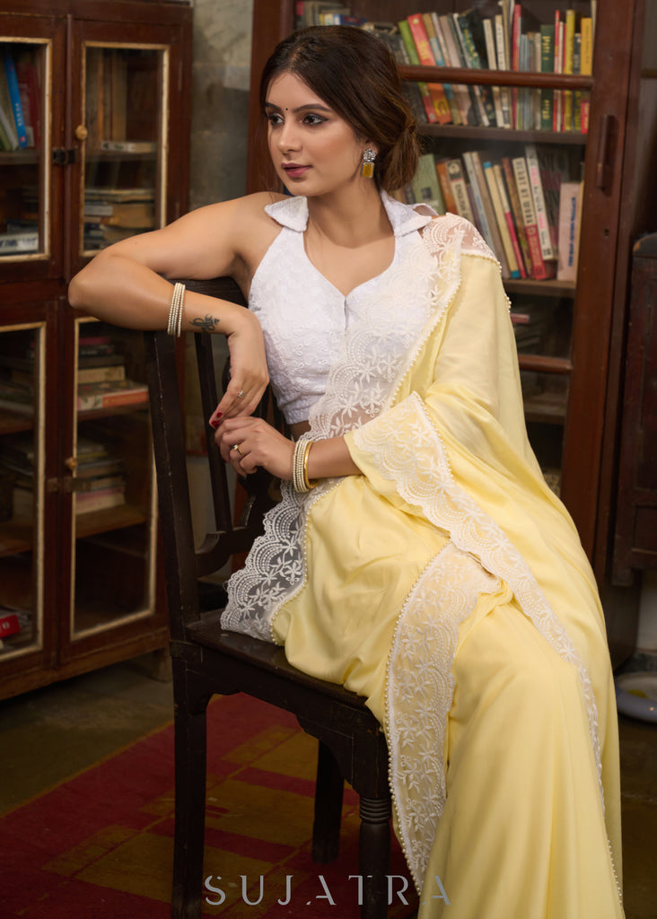 Gracious pastel yellow modal cotton saree highlighted with beautiful laces