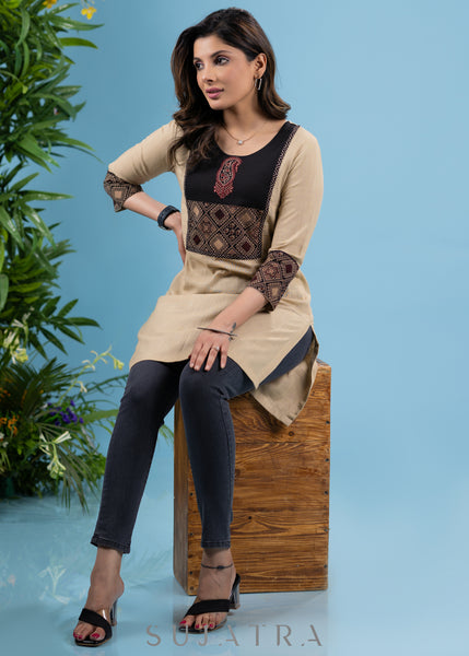 Elegant beige cotton tunic with ajrakh yoke highlighted with applique motif