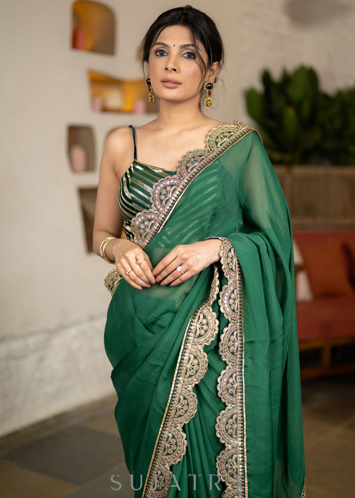 Graceful Bottle Green Organza Saree Highlighted With Matching Scalloped Lace