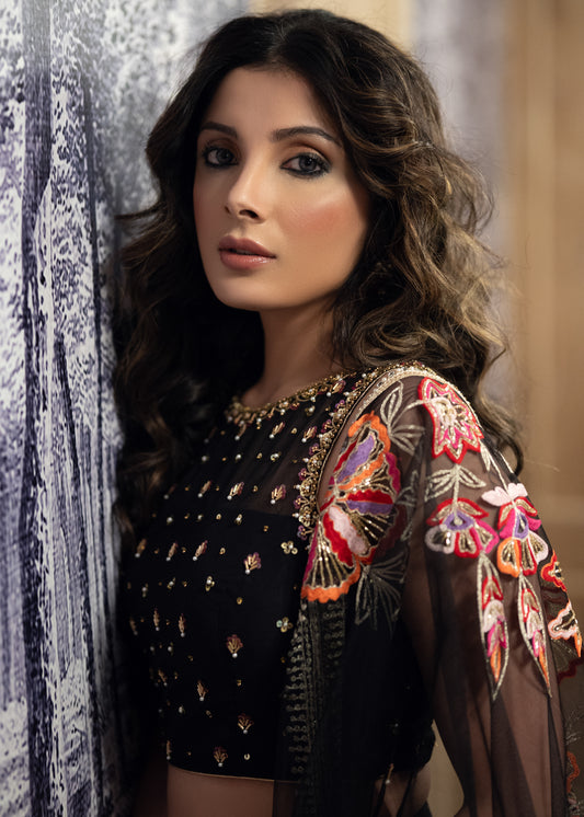 Classic Black Cotton Silk Lehenga paired with delicately embellished net dupatta accentuated with heavy floral embroidery and hand embellishments