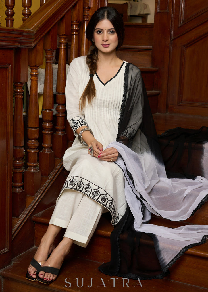 Elegant off-white cotton kurta adorned with intricate embroidery complimeted by matching pants - Dupatta Optional