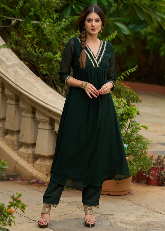Elegance redefined in this captivating green georgette lace kurta - Pant additional