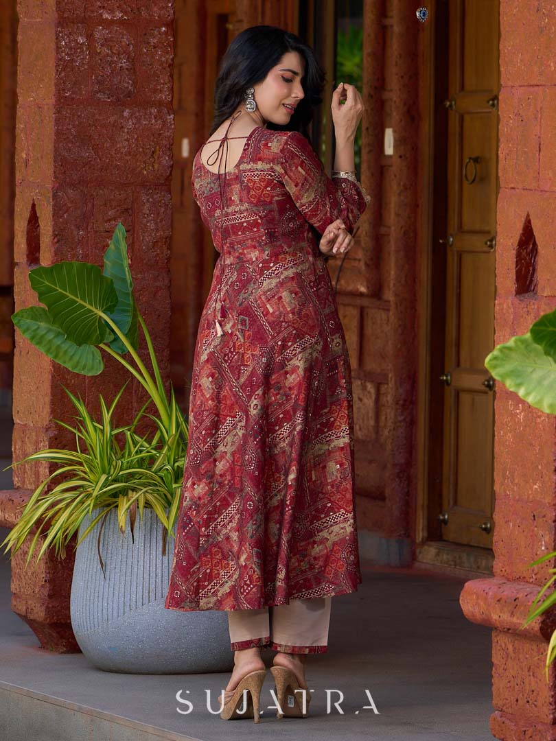 Exquisite deep maroon printed kurta with a graceful bias silhouette, intricate handwork on the yoke, and scalloped sleeve detailing.