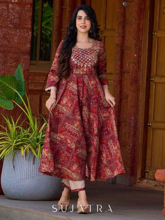 Exquisite deep maroon printed kurta with a graceful bias silhouette, intricate handwork on the yoke, and scalloped sleeve detailing.