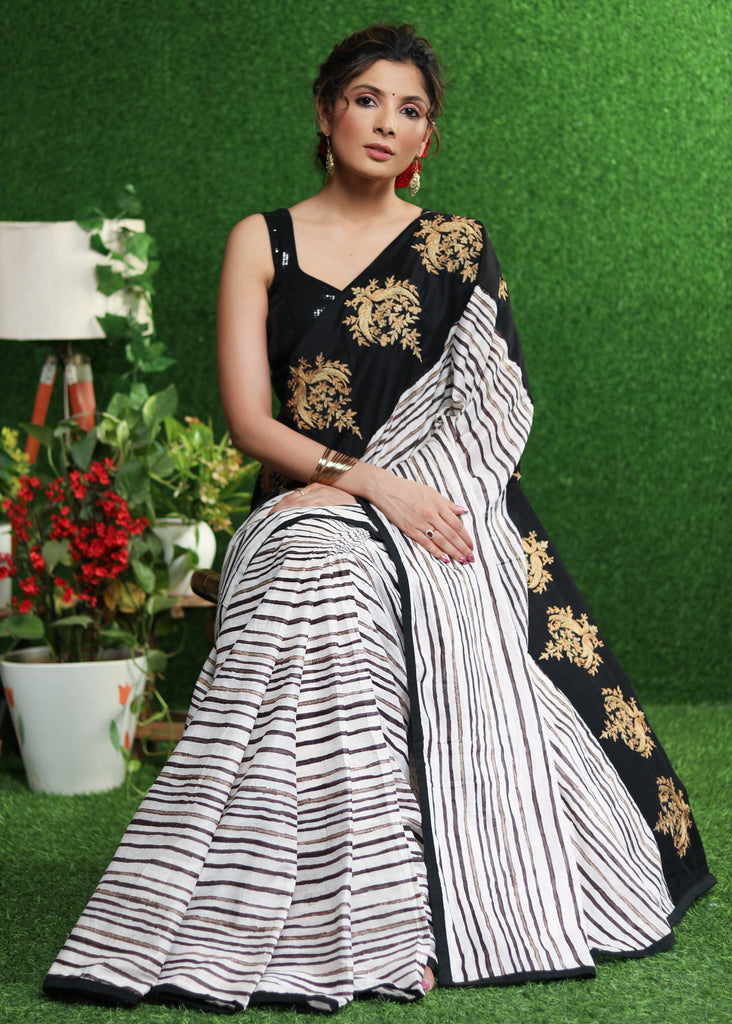 Gorgeous white striped saree with gold embroidered border on pallu