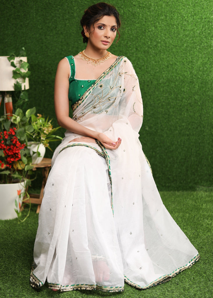 Elegant white saree with delicate hand-embroidery and green Banasari border