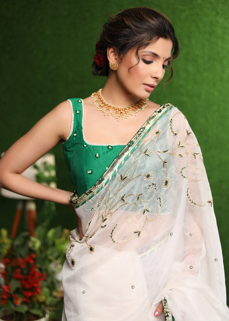 Elegant white saree with delicate hand-embroidery and green Banasari border
