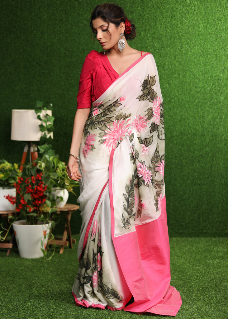 Beautiful white chiffon saree with pink hand painted floral motif & pink border
