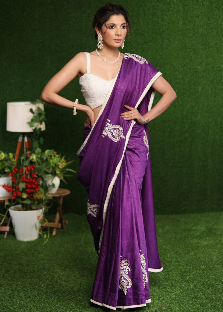 Elegant purple cotton Silk saree with beige embroidery motifs.