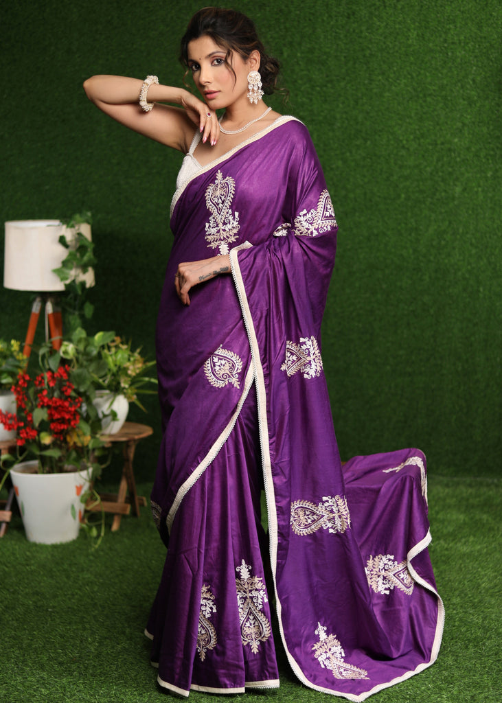 Elegant purple cotton Silk saree with beige embroidery motifs.