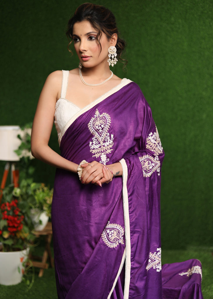 Elegant purple cotton Silk saree with beige embroidery motifs.