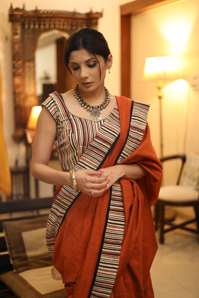 Exquisite rust Cotton plain saree with line Ajrakh border