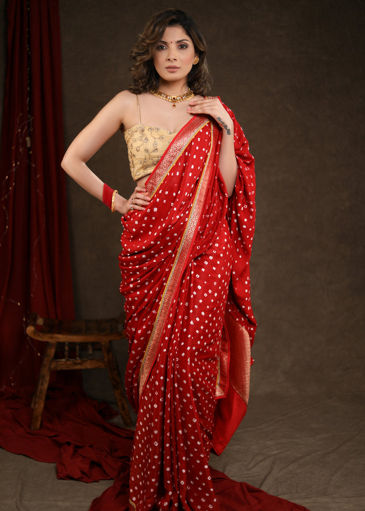 Radiant Red Bandhej Saree with Delicate Gold And Banarasi Detailing