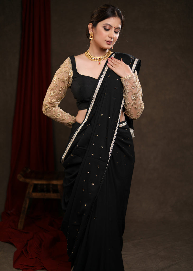 Classy Black Rayon Saree Adorned with Delicate Gold Hand Embroidery & Lace