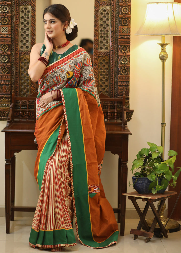Mesmerizing rust Cotton saree with exclusive hand painted Madhubani Pallu, line pleats & mirror work border