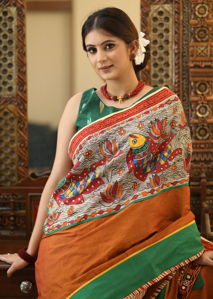 Mesmerizing rust Cotton saree with exclusive hand painted Madhubani Pallu, line pleats & mirror work border