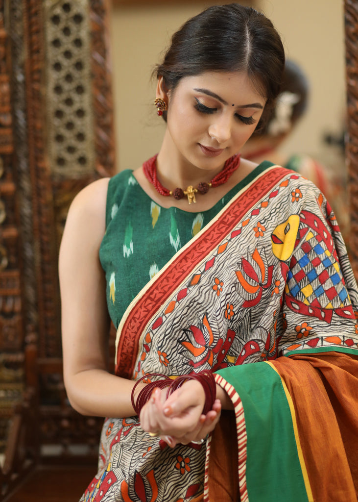 Mesmerizing rust Cotton saree with exclusive hand painted Madhubani Pallu, line pleats & mirror work border