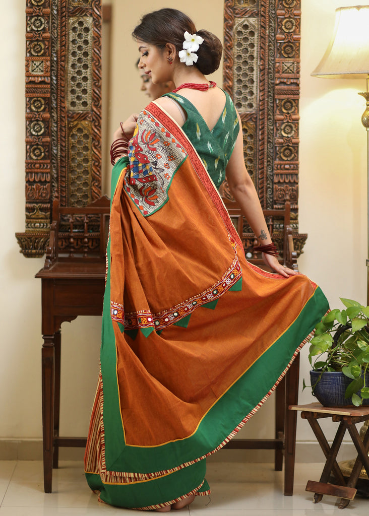 Mesmerizing rust Cotton saree with exclusive hand painted Madhubani Pallu, line pleats & mirror work border