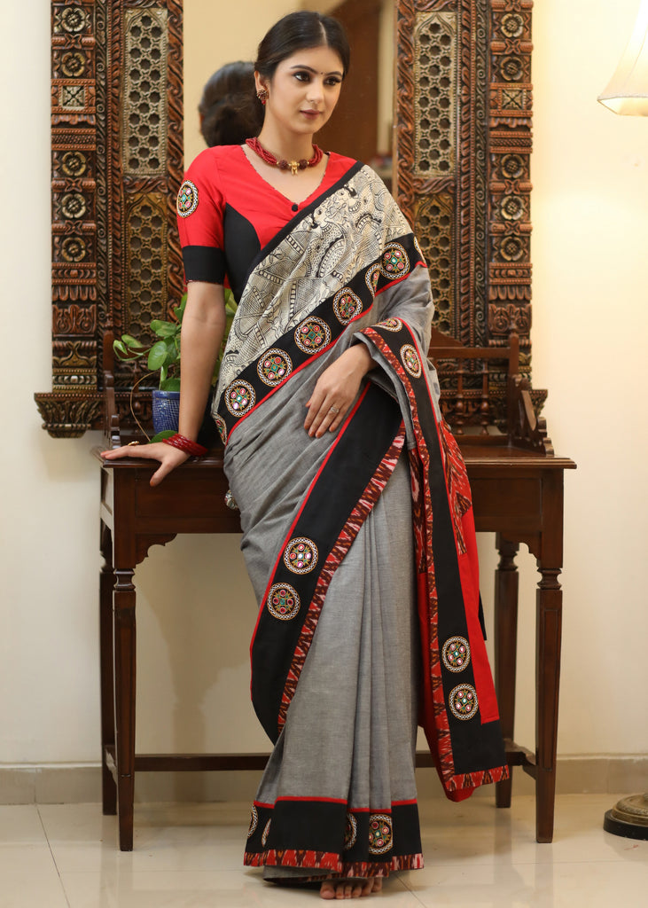 Stylish grey Cotton saree with graceful Madhubani hand painted Pallu and mirror work