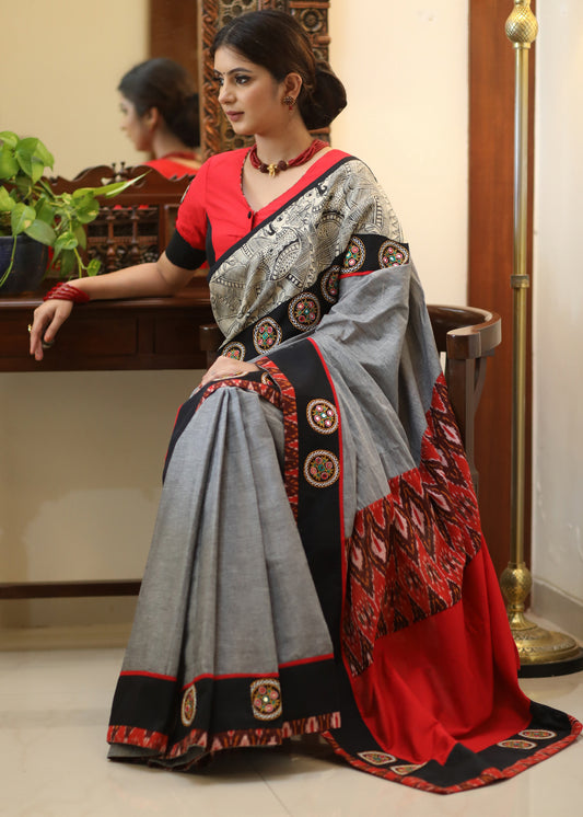 Stylish grey Cotton saree with graceful Madhubani hand painted Pallu and mirror work