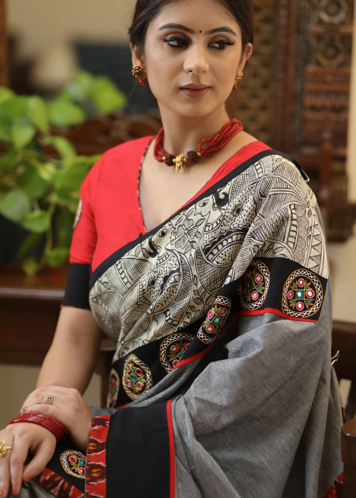 Stylish grey Cotton saree with graceful Madhubani hand painted Pallu and mirror work
