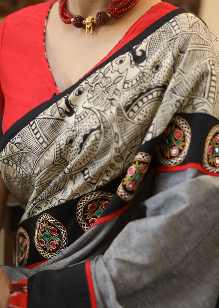 Stylish grey Cotton saree with graceful Madhubani hand painted Pallu and mirror work