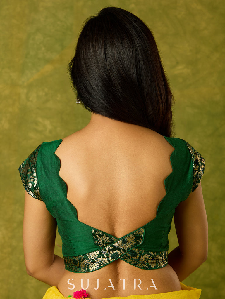 Festive dark green cap sleeve blouse with rich Banarasi combination