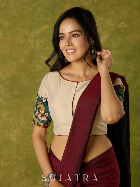 Beige cotton silk blouse beautifully blended with artistic kalamkari detailing.