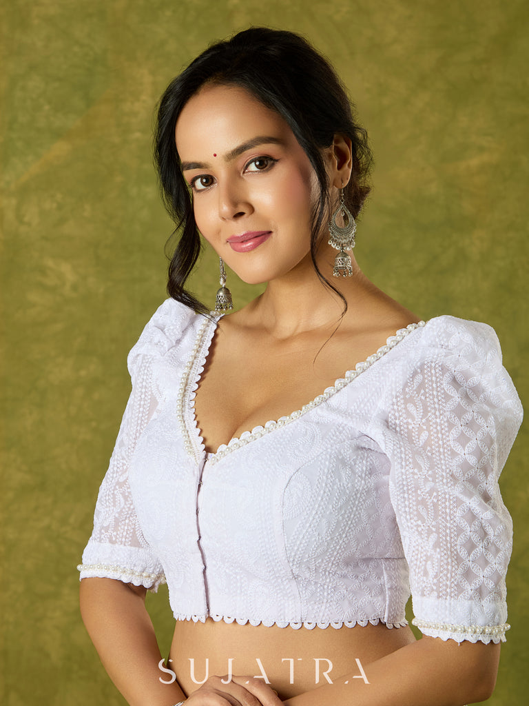 Elegant white blouse with chikankari, moti embroidery, and lace.