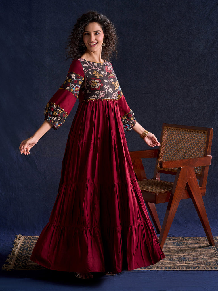 Timeless Maroon Rayon Layered Gown with Gathers and Hand Painted Kalamkari Accents featuring Puffy Sleeves and Delicate Golden Accents