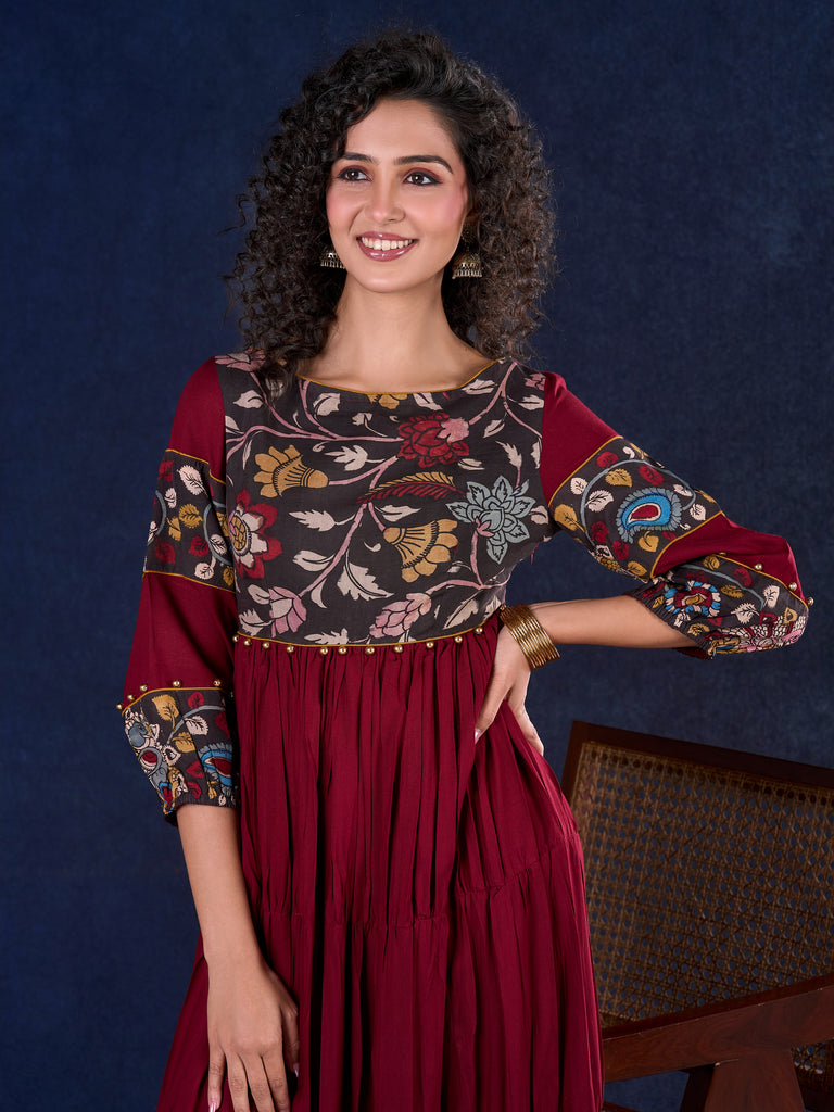 Timeless Maroon Rayon Layered Gown with Gathers and Hand Painted Kalamkari Accents featuring Puffy Sleeves and Delicate Golden Accents
