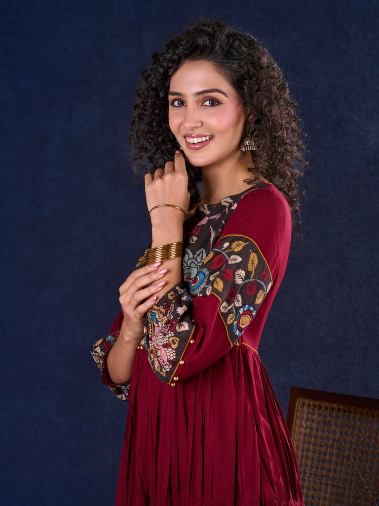 Timeless Maroon Rayon Layered Gown with Gathers and Hand Painted Kalamkari Accents featuring Puffy Sleeves and Delicate Golden Accents