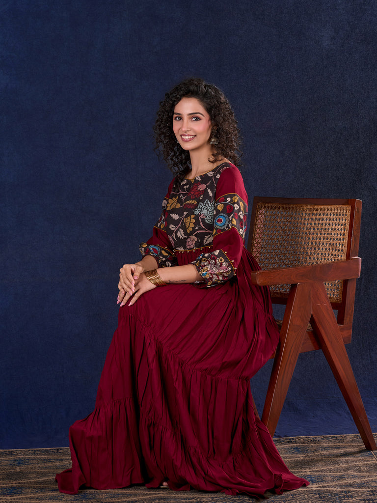 Timeless Maroon Rayon Layered Gown with Gathers and Hand Painted Kalamkari Accents featuring Puffy Sleeves and Delicate Golden Accents