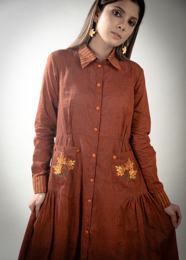 Rust cotton dress with embroidered pockets