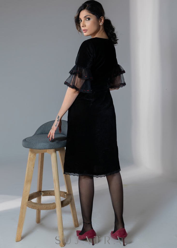 Party wear black velvet dress with net sleeves & red stone work detailing on the neck