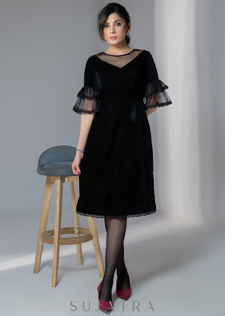 Party wear black velvet dress with net sleeves & red stone work detailing on the neck