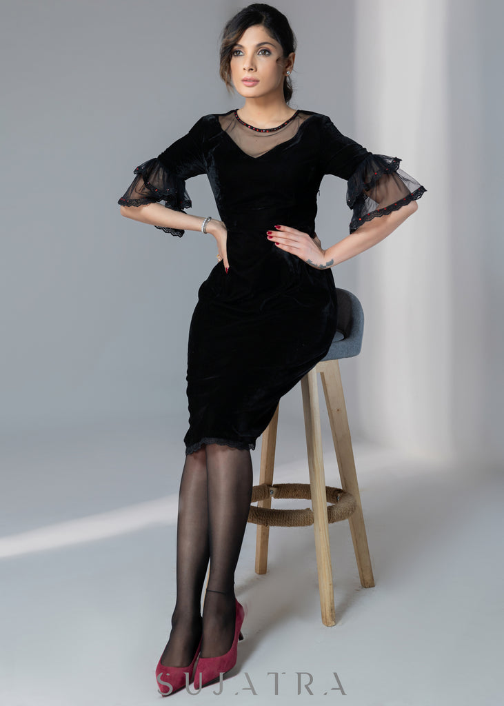 Party wear black velvet dress with net sleeves & red stone work detailing on the neck