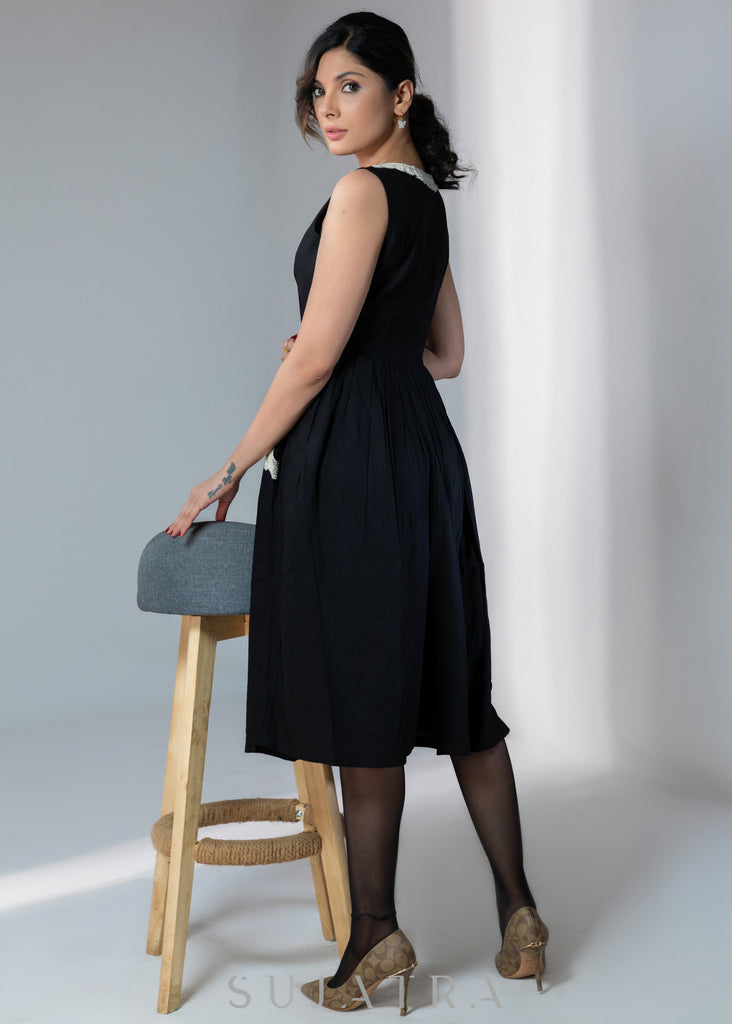 Black sleeveless rayon dress with off white lace detailing on neck and pockets