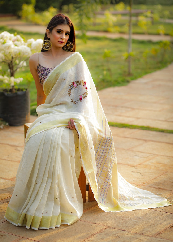 Exclusive beige pure linen saree with intricate embroidery & mirror work embellishments