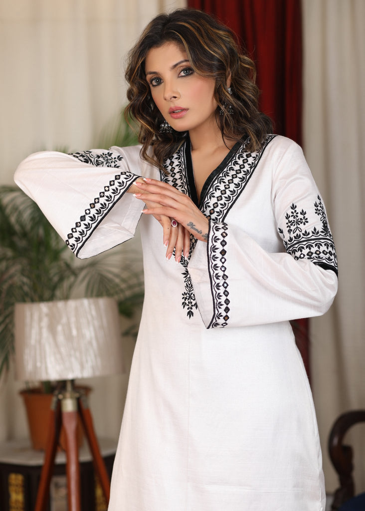 Straight ebony and ivory appliqued bell sleeve embroidered dress highlighted with velvet lace