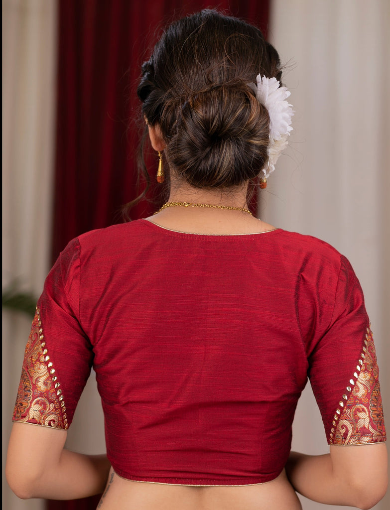 Elegant maroon cotton silk blouse highlighted with banarasi cutout on sleeves