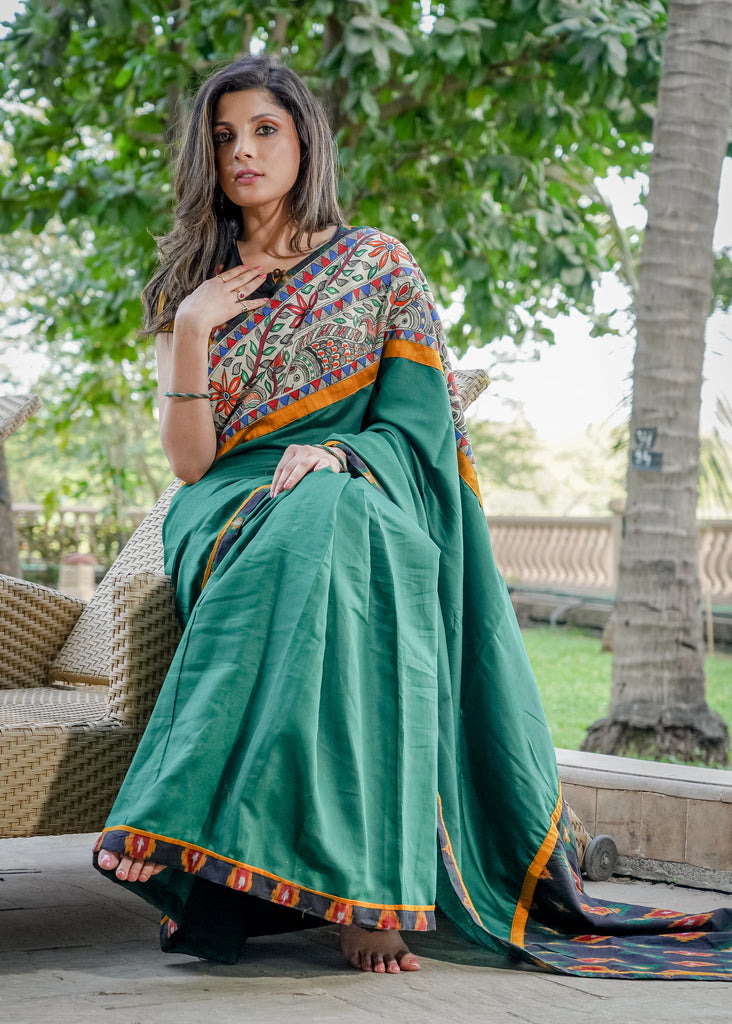 Satin bottle green saree with madhubani painting and Ikat combination pallu