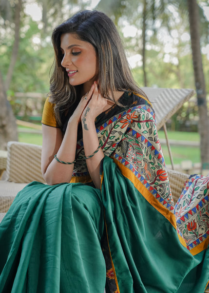 Satin bottle green saree with madhubani painting and Ikat combination pallu