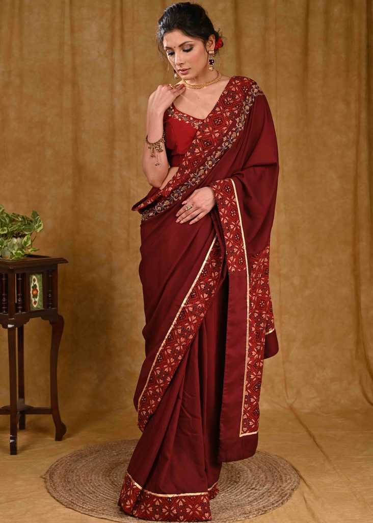 Chique Maroon Rayon Saree With Elegant Zardosi Work And Ajrakh Border