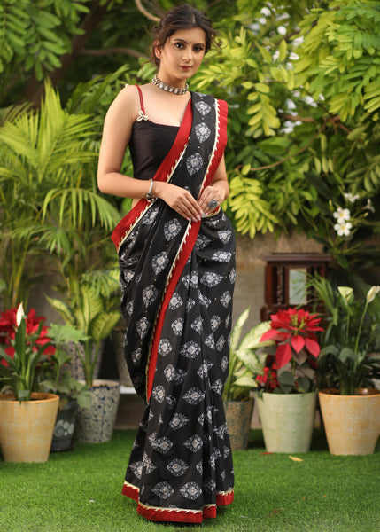 Elegant black printed Cotton saree with maroon Gota Patti border and stone embellishment