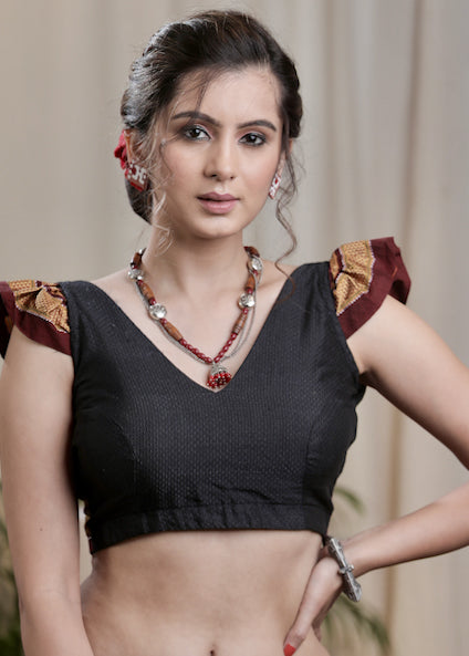 Smartly Designed Black Khun Fabric Blouse with Flap Sleeves and Bow at Back.Lining Given