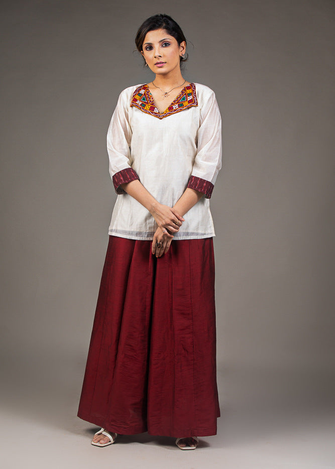 Exclusive white chanderi top with hand embroidered kutchi mirror work collar